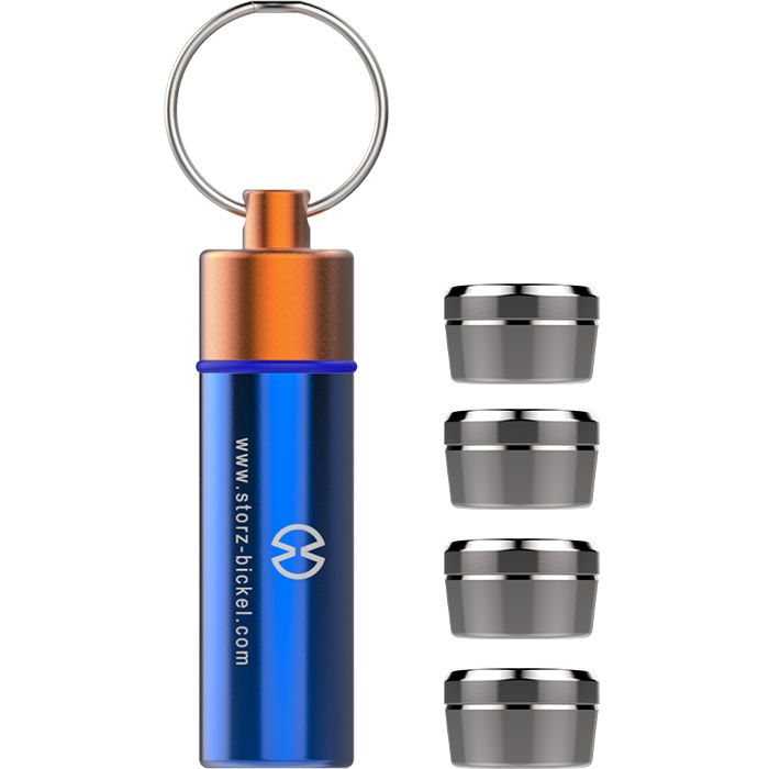 Blue Storz & Bickel Capsule Caddy with key ring beside four metal dosing capsules